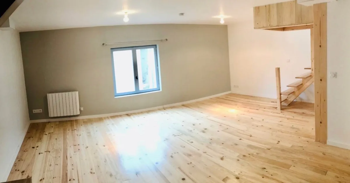 Pièce rénovée à Canéjan avec parquet bois clair, mur d'accent gris-vert et escalier bois, par JS Ambiance Peinture